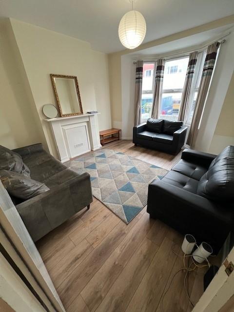 Bright, welcoming living room with a bay window...