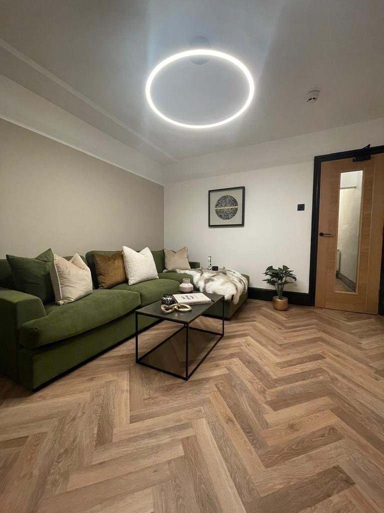 Modern and stylish living room featuring a comf...