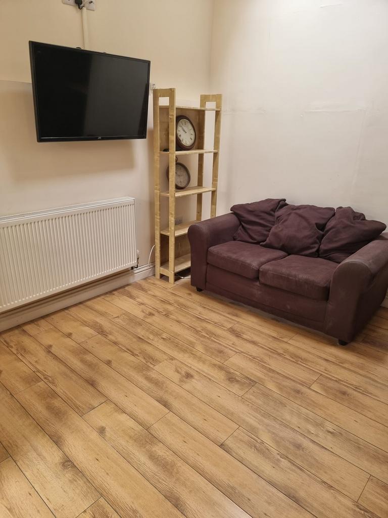 Compact, well-kept living area with warm wood-e...