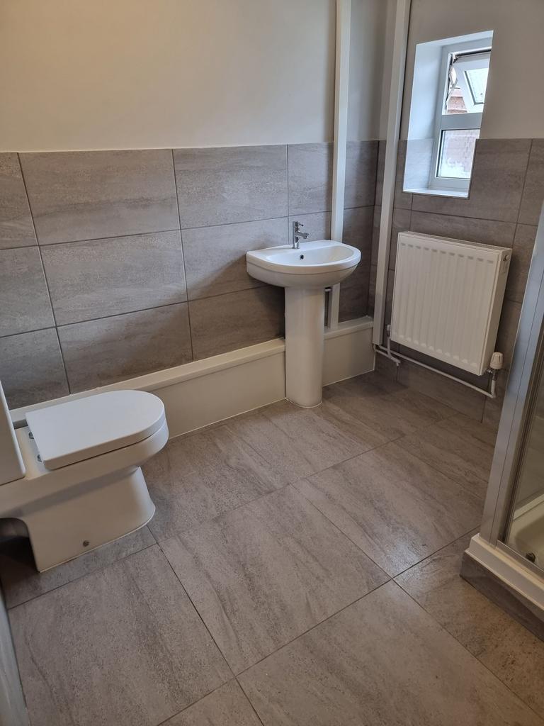 Bright, recently renovated bathroom with modern...