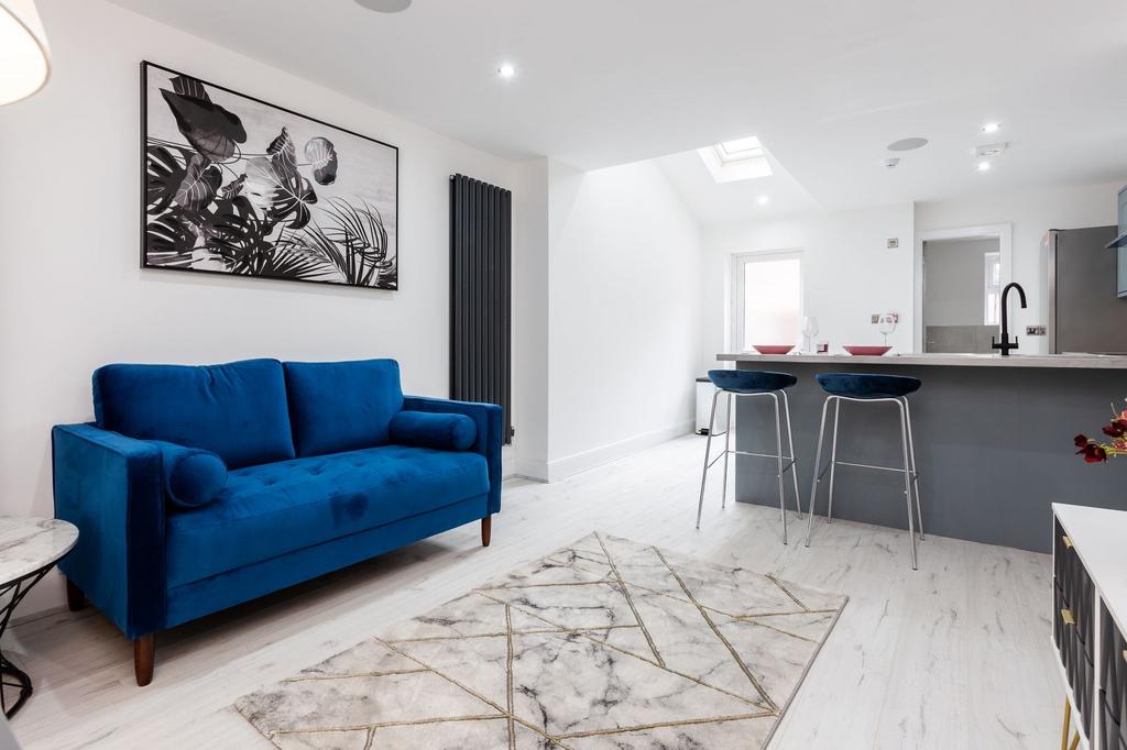 Bright and stylish living room featuring a stri...