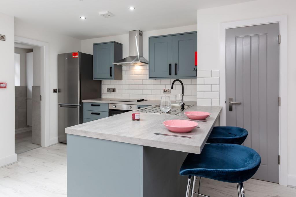 Modern and stylish kitchen featuring blue cabin...