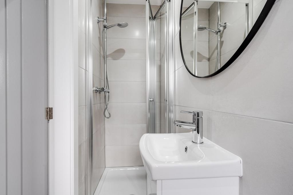 A clean and modern bathroom featuring a shower ...