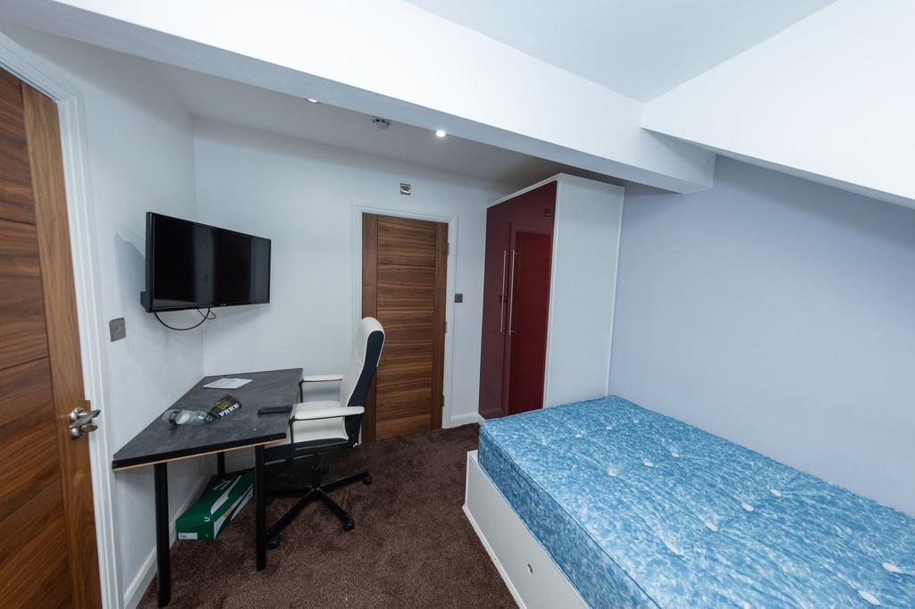 A well-maintained bedroom featuring a single be...