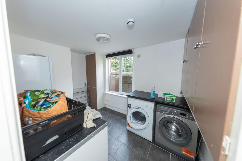 A functional kitchen area featuring laundry app...