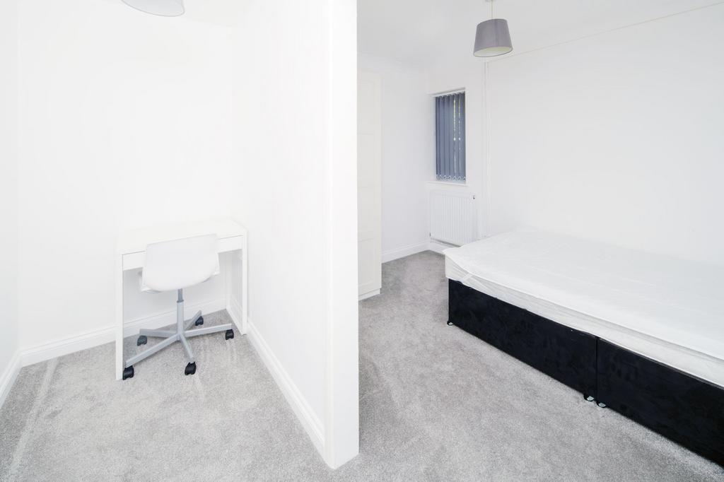 Bright, freshly redecorated bedroom with neutra...