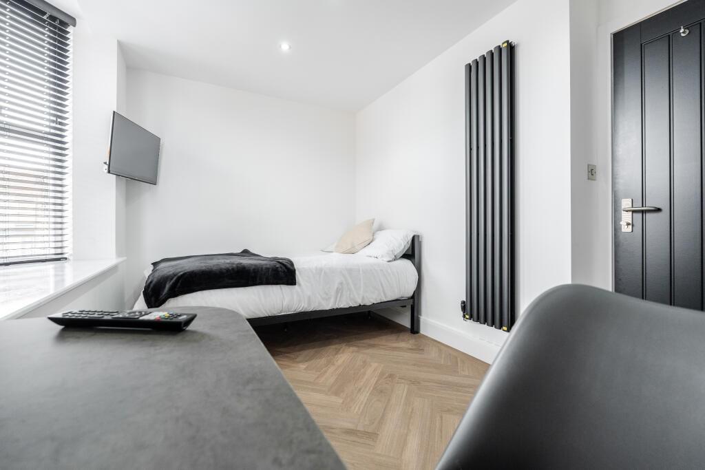 A bright and modern master bedroom featuring a ...