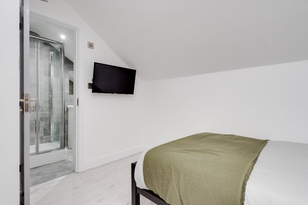 A well-lit, modern master bedroom featuring a l...