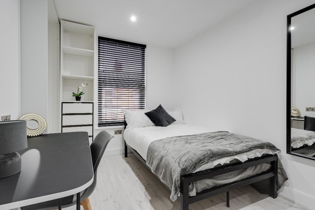 A bright and welcoming double bedroom with a co...