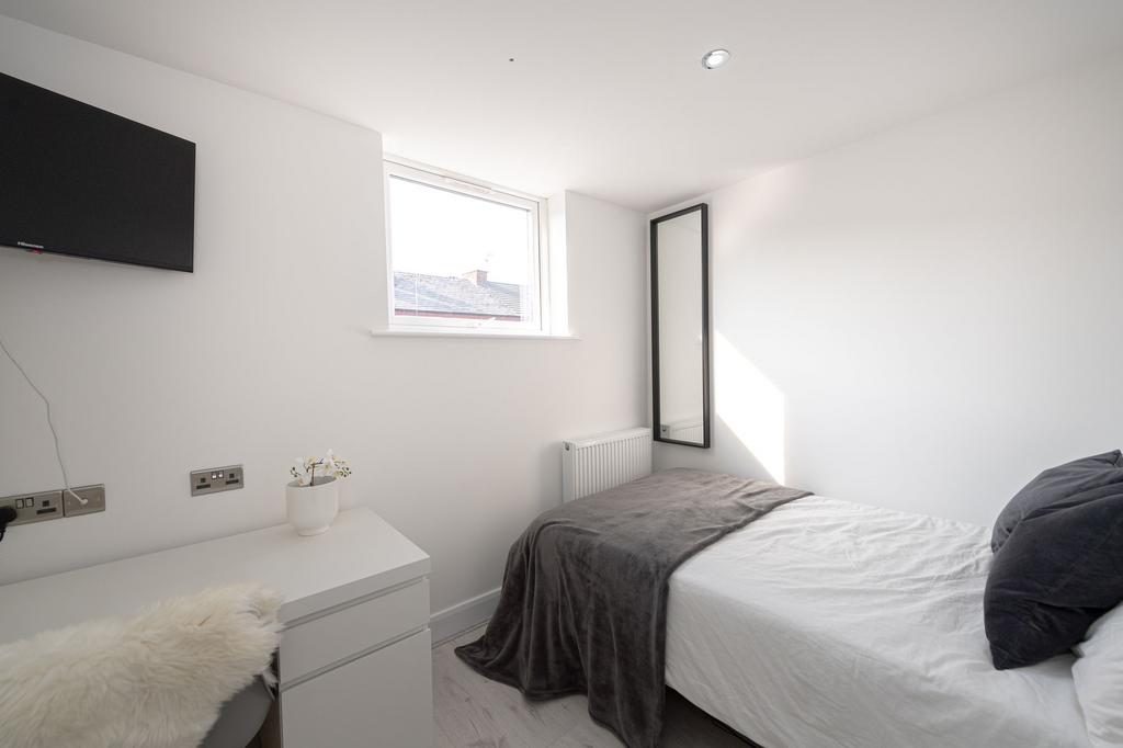 Bright and minimalist single bedroom featuring ...