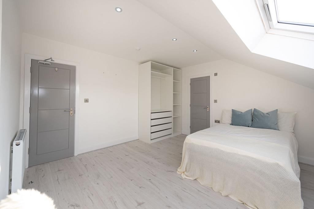 Bright and inviting bedroom with a comfortable ...