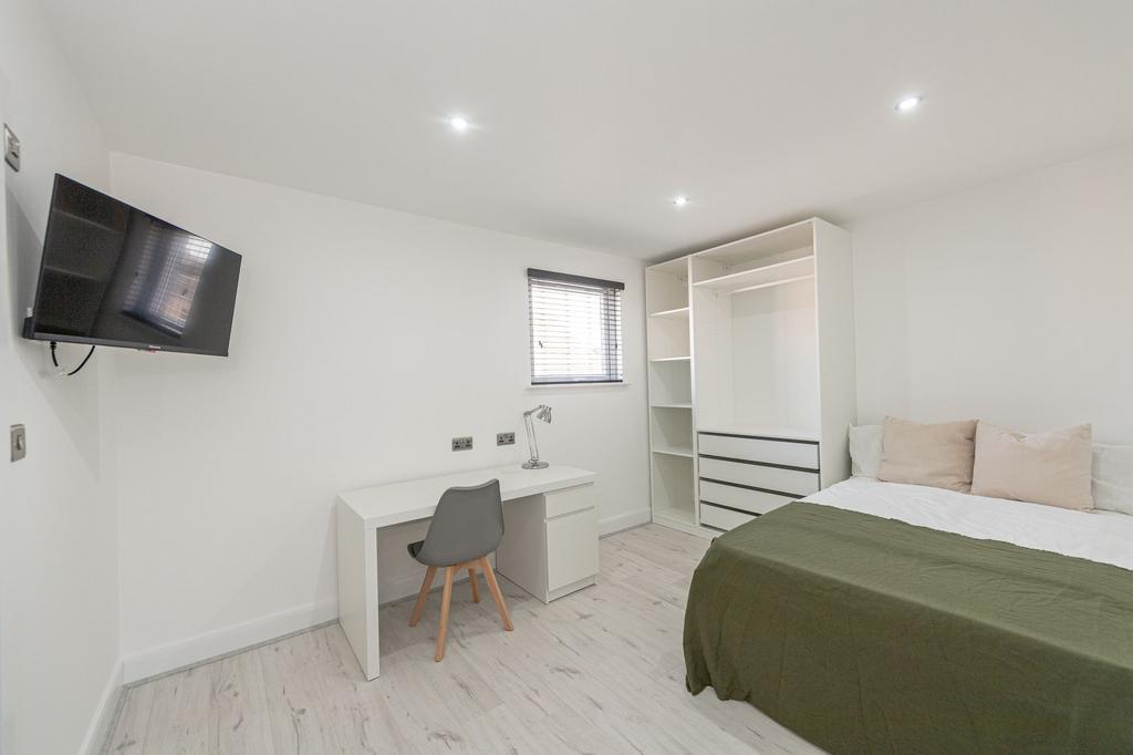 A modern and minimalist bedroom featuring a dou...