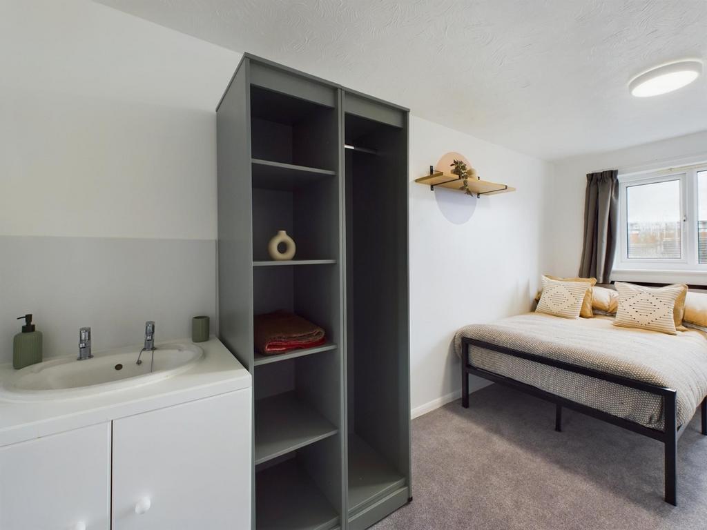 A spacious and well-lit double bedroom featurin...