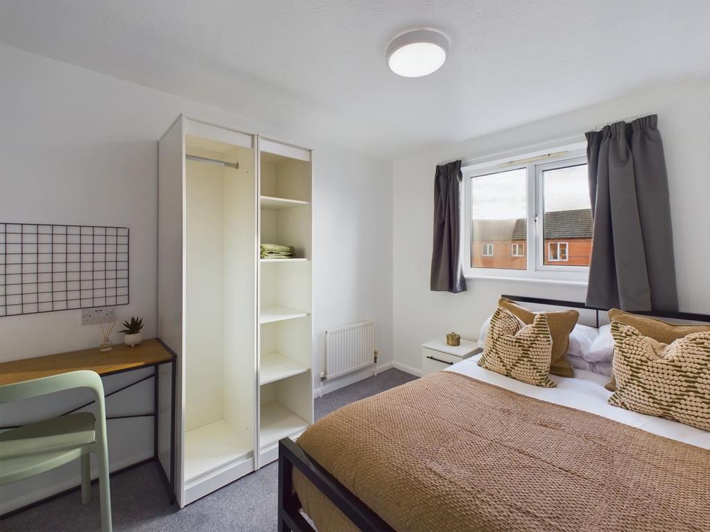 A bright and inviting double bedroom with moder...