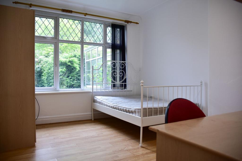 Bright and airy bedroom with large window views...