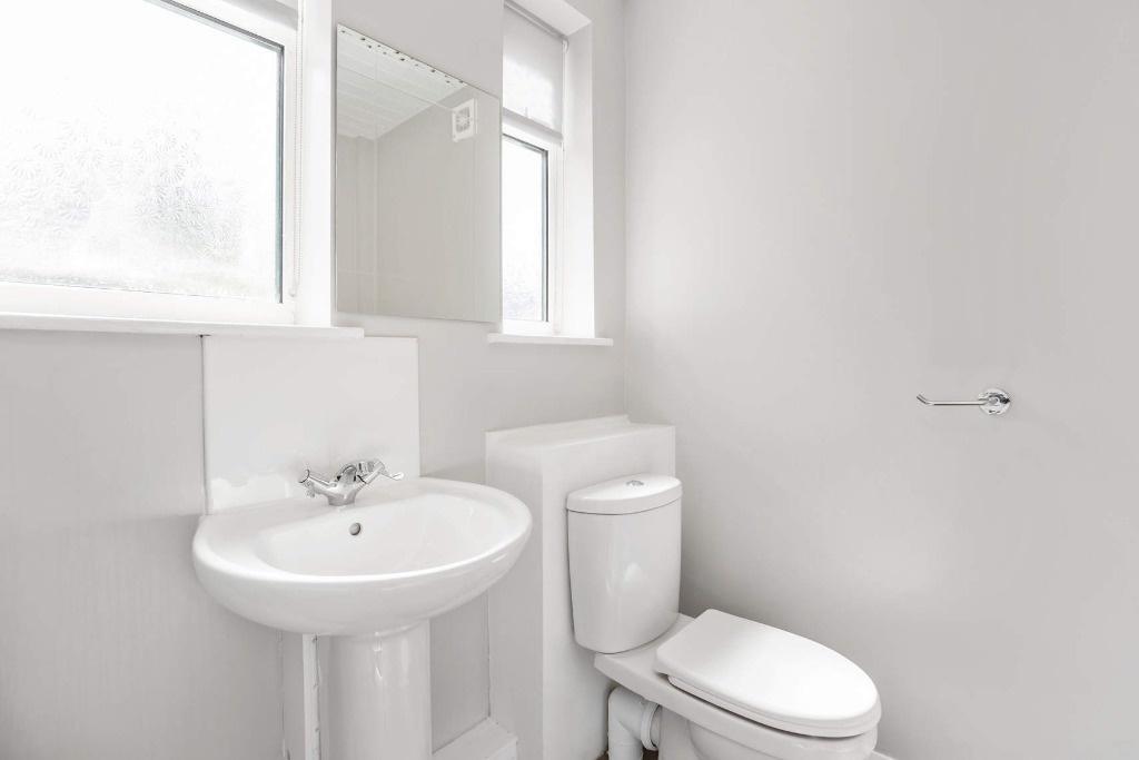 Bright, modern bathroom with white sanitaryware...