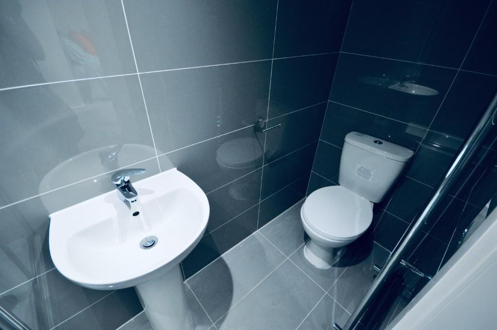 A clean and modern bathroom featuring a toilet ...