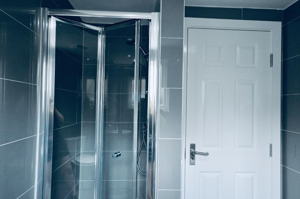 A modern bathroom with a spacious shower enclos...