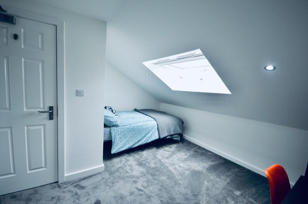 A bright and spacious master bedroom with a sle...