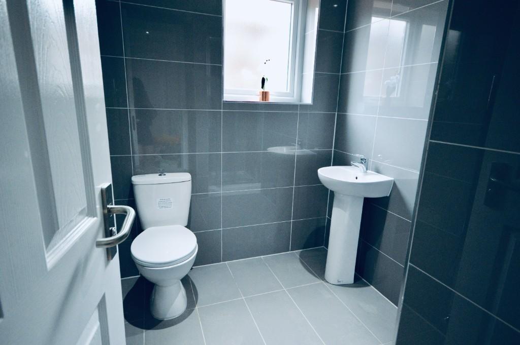 A clean and modern bathroom featuring a toilet ...