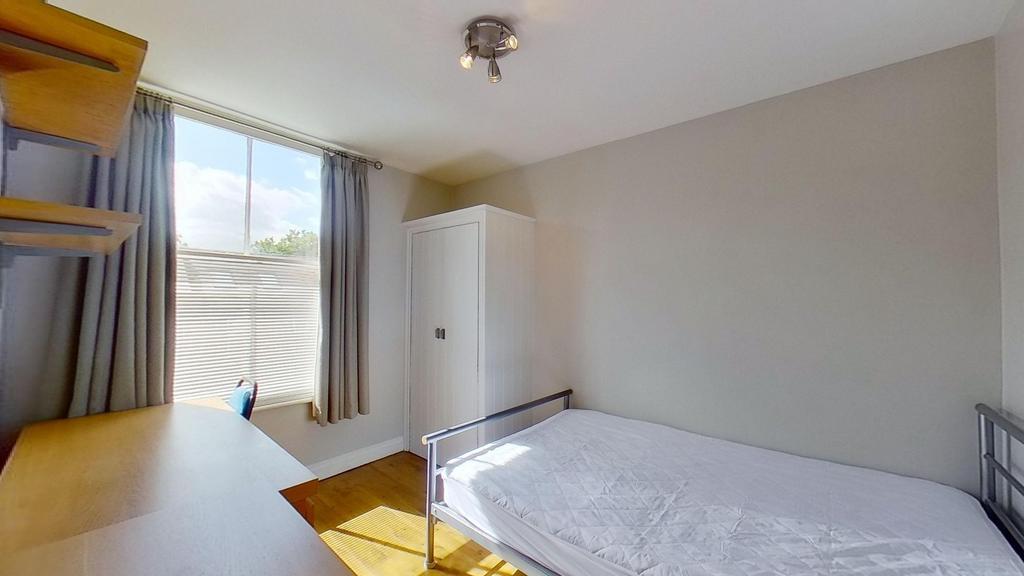 Bright, tidy bedroom with large sash window and...