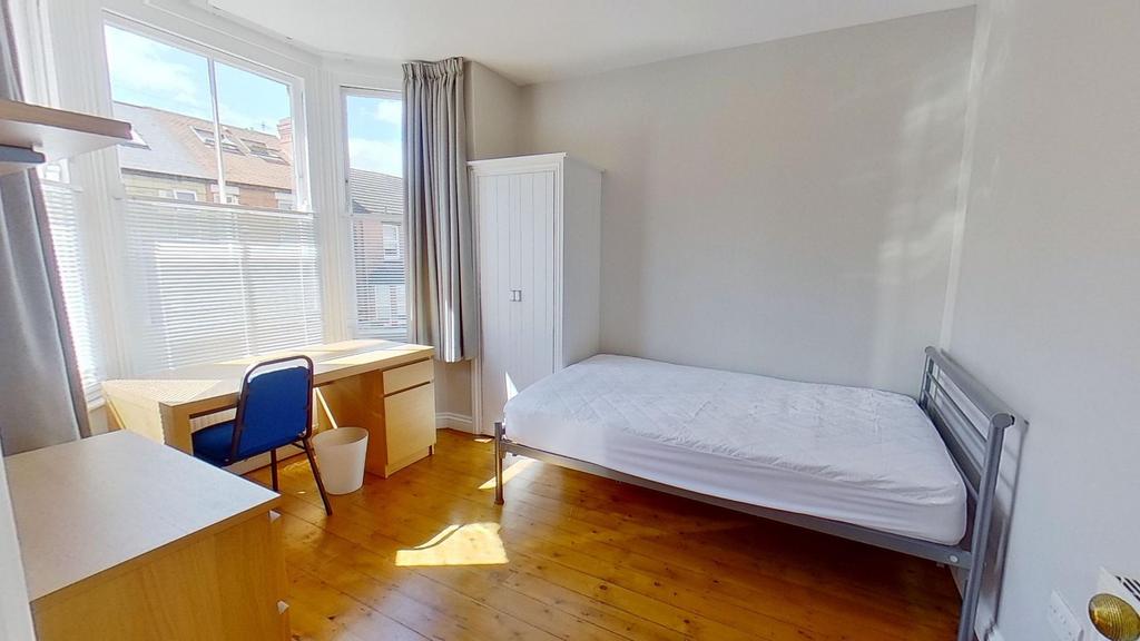 Bright, neatly presented bedroom with a large b...