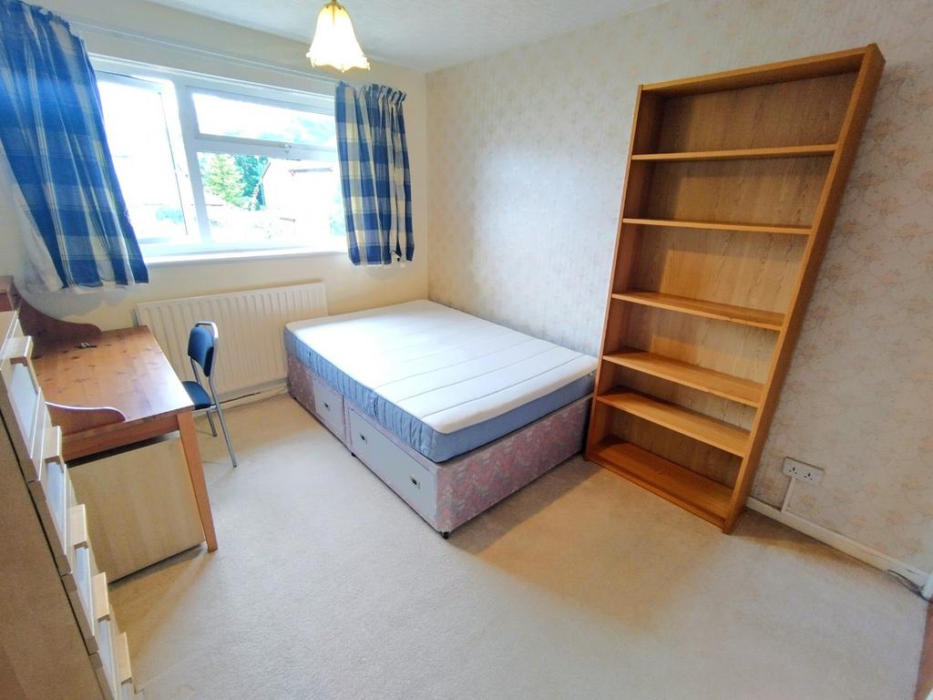 Bright single bedroom with a large window, neat...