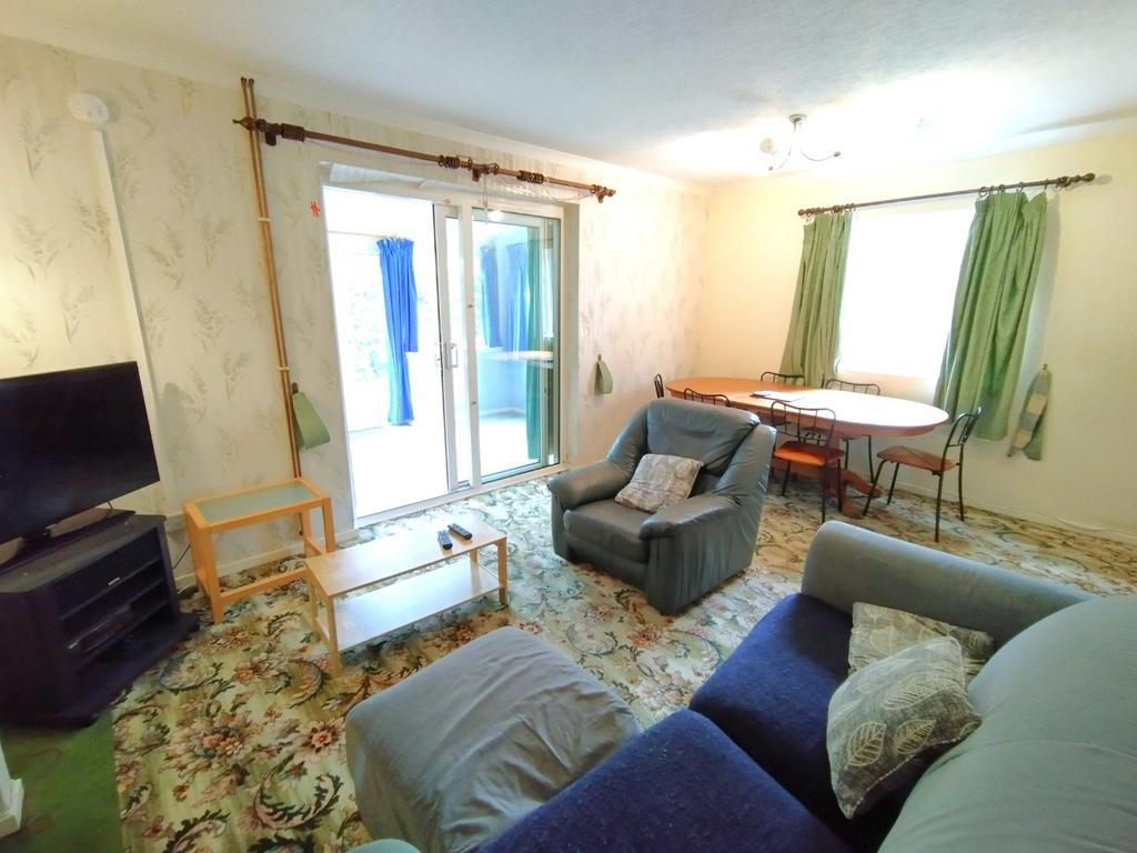 Bright, comfortable living room with sliding do...