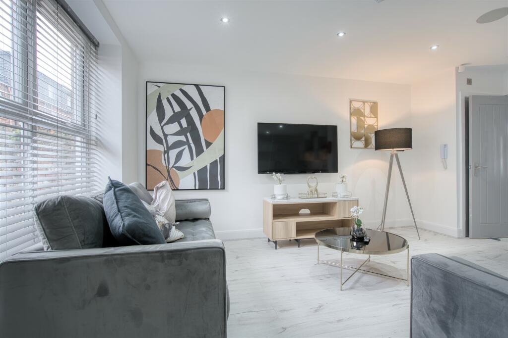 Bright and contemporary living room featuring c...
