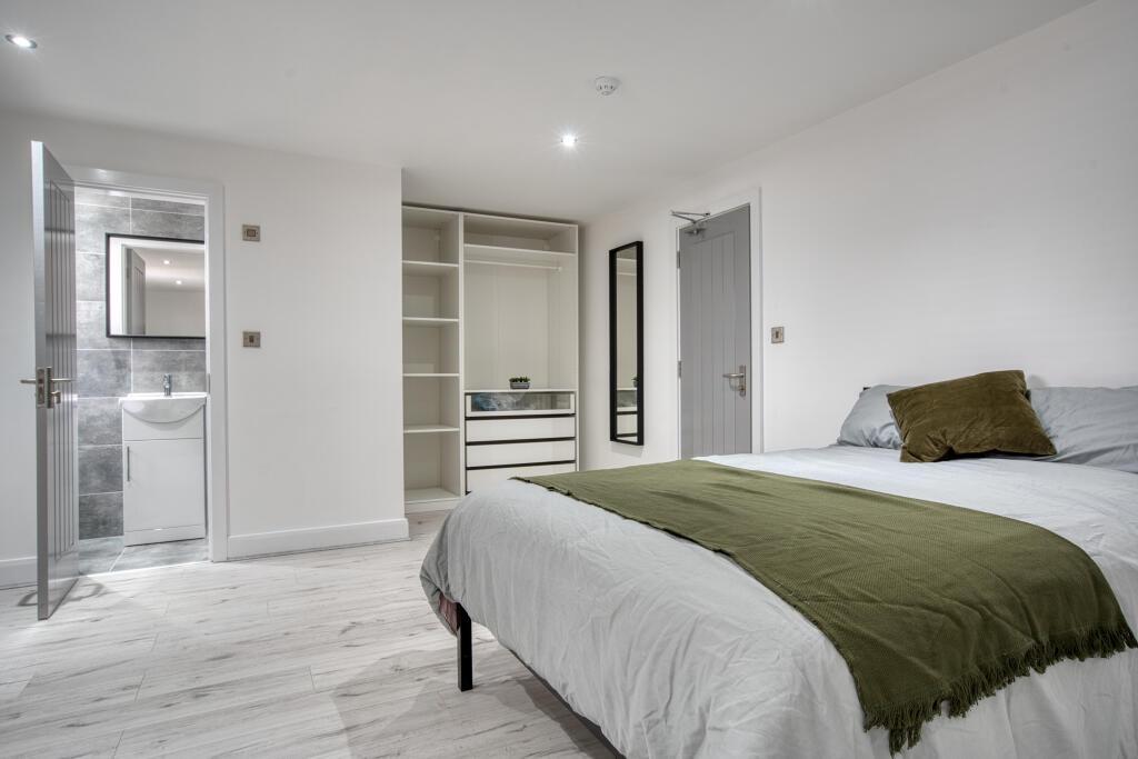 A spacious and well-maintained master bedroom f...