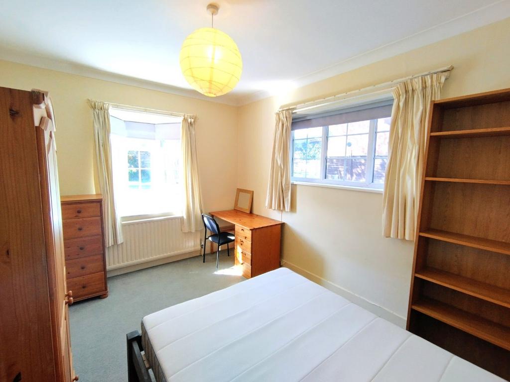 Bright, tastefully furnished bedroom with two l...