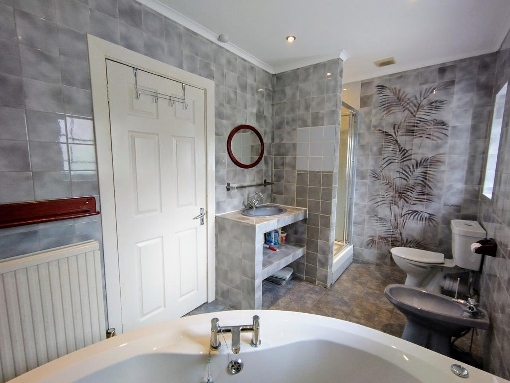 Bright, well-appointed bathroom featuring a fre...