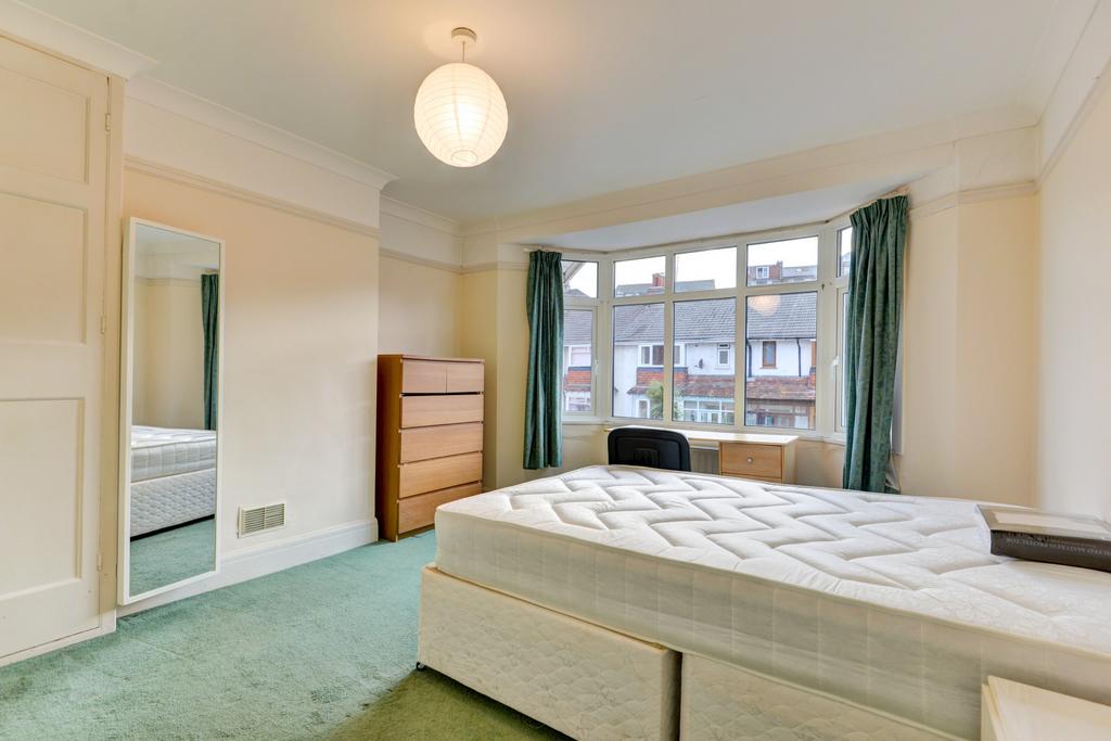 Bright, spacious bedroom with a large bay windo...