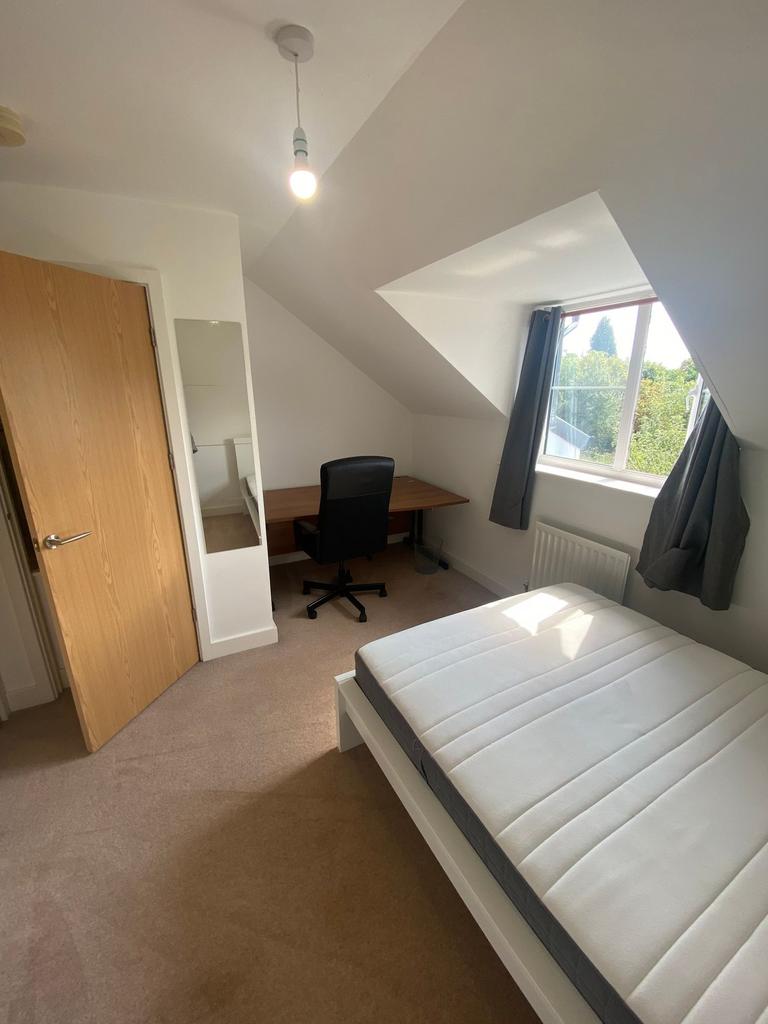 A bright, well-maintained bedroom featuring a c...