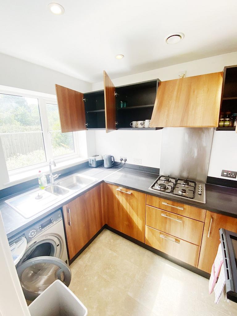 Bright modern kitchen with wood-effect cabinets...