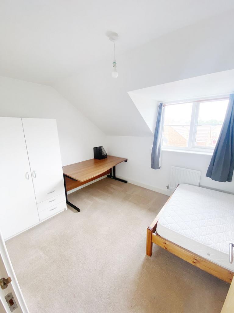 Bright, neatly presented bedroom with a large w...