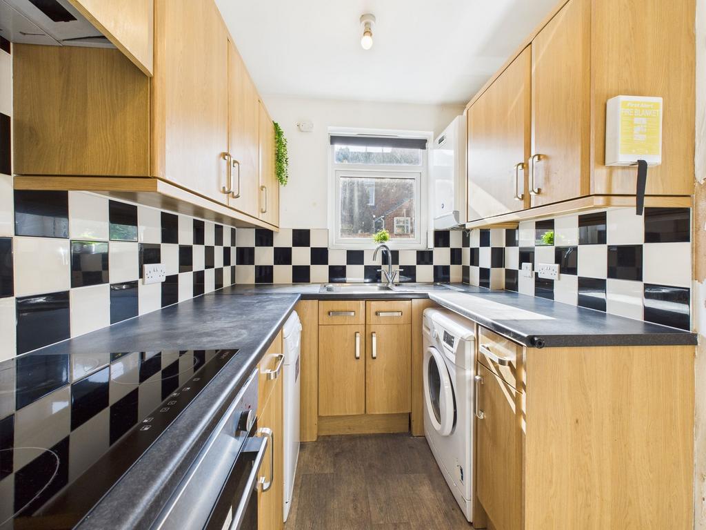 Bright and modern kitchen with wooden cabinets,...