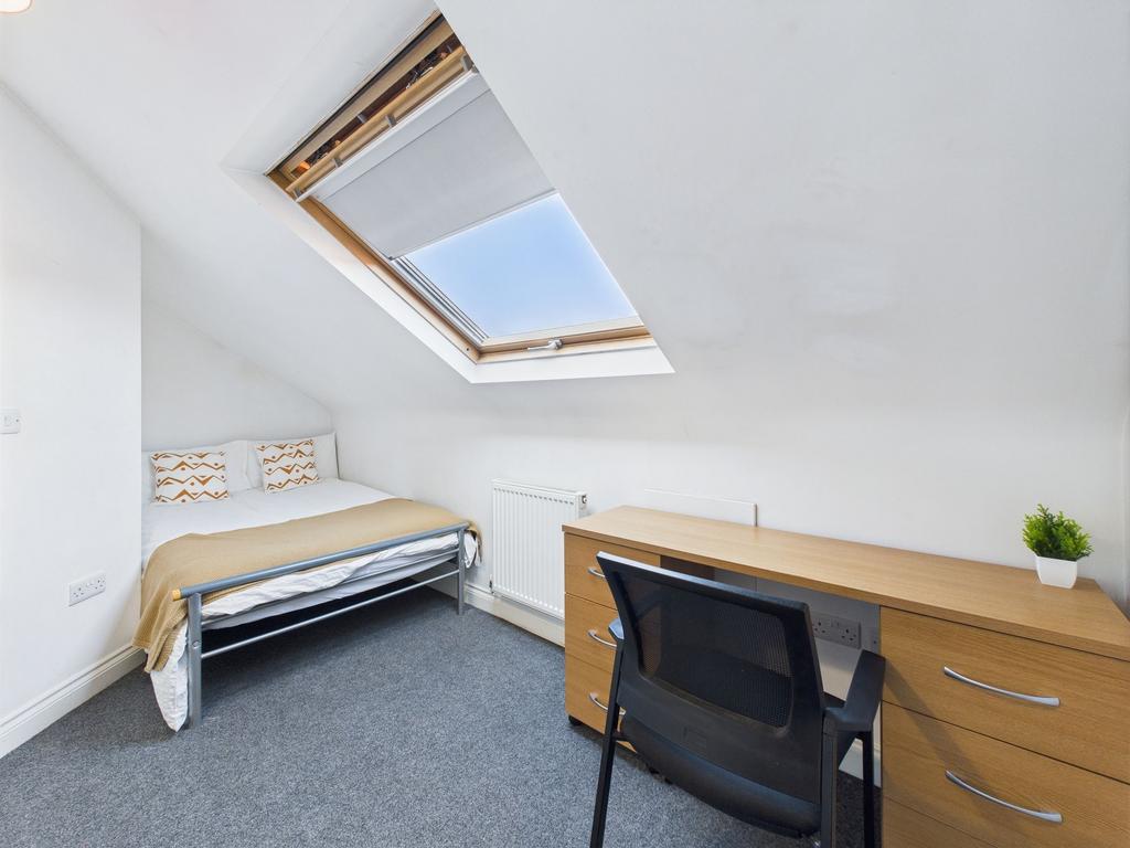 Bright and welcoming bedroom featuring a single...
