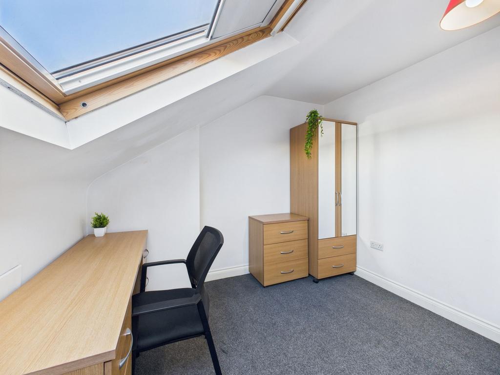 A bright, well-maintained bedroom featuring a s...