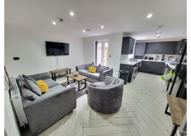 Modern and spacious living room featuring comfo...