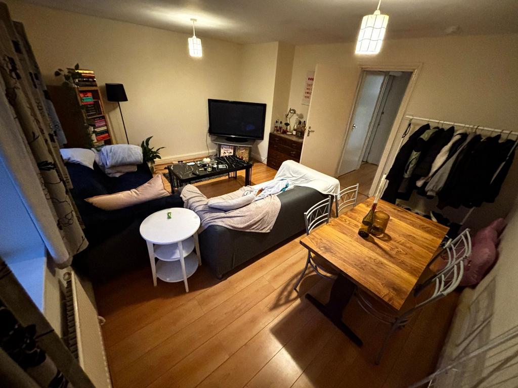 Warm, furnished living room with a comfy sofa a...