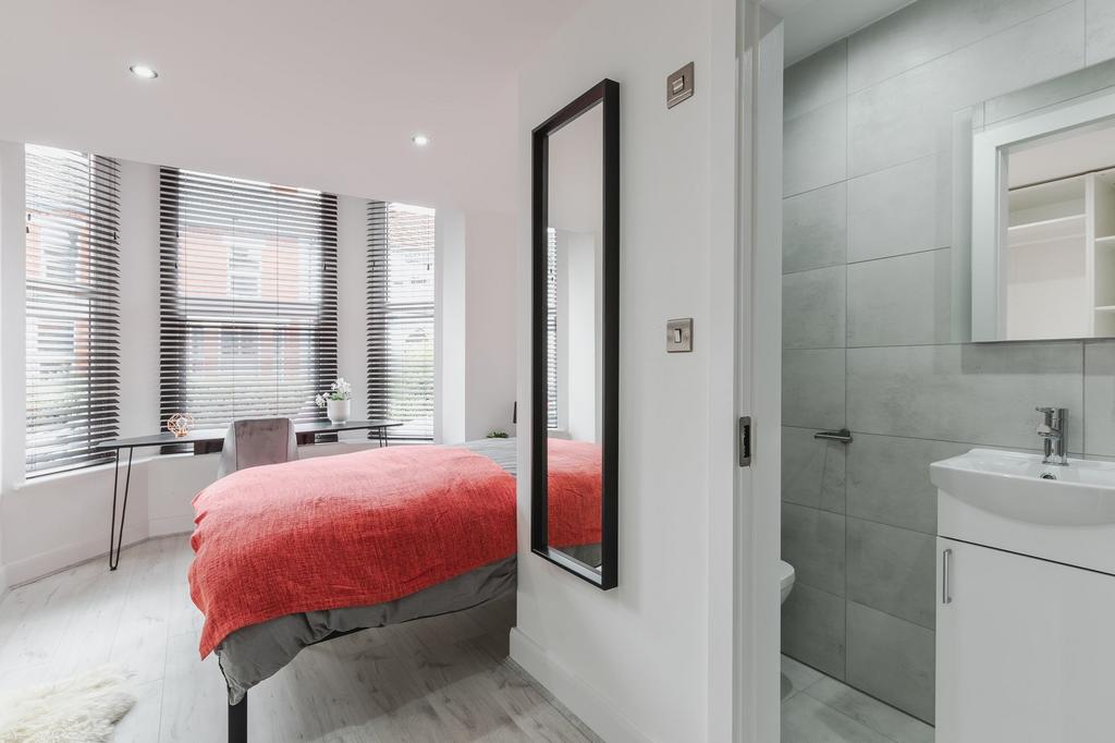 Bright and modern bedroom with large windows an...