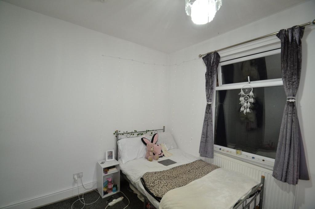 Cozy single bedroom with a neatly made bed, sof...