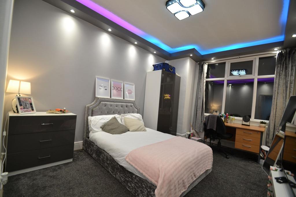 Stylish double bedroom with a plush upholstered...