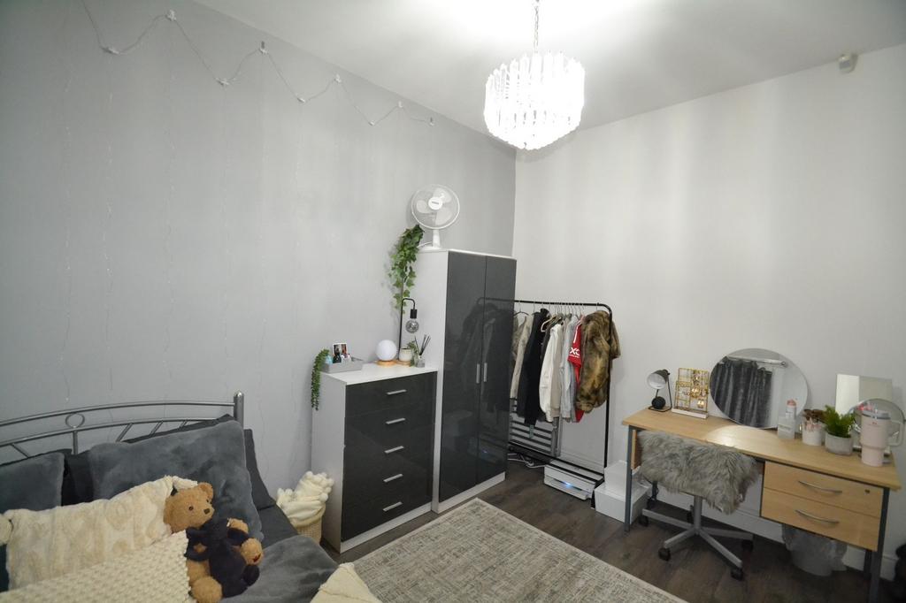 Well-presented bedroom with a cosy bed, neutral...