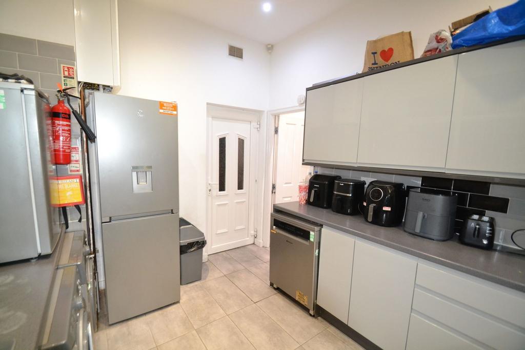 Modern galley kitchen with sleek grey cabinetry...
