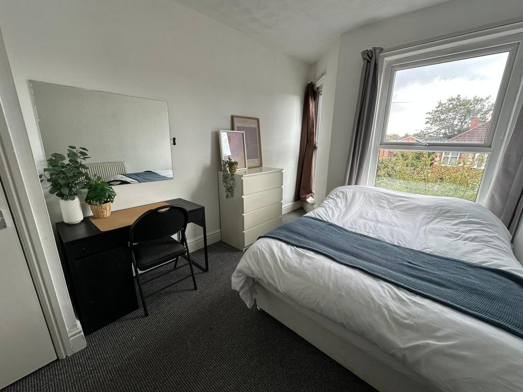 A bright and inviting double bedroom featuring ...