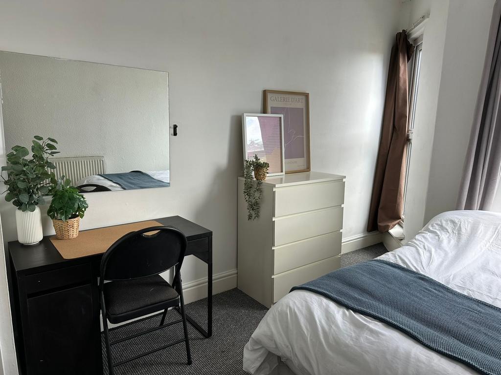 Bright and welcoming master bedroom featuring a...