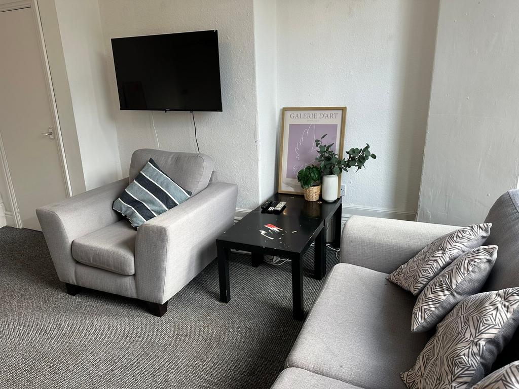 A modern and cozy living room with two comforta...