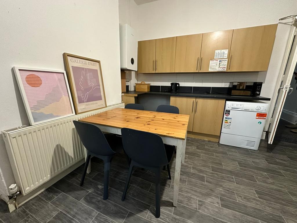 A modern, clean kitchen with wooden cabinets, b...